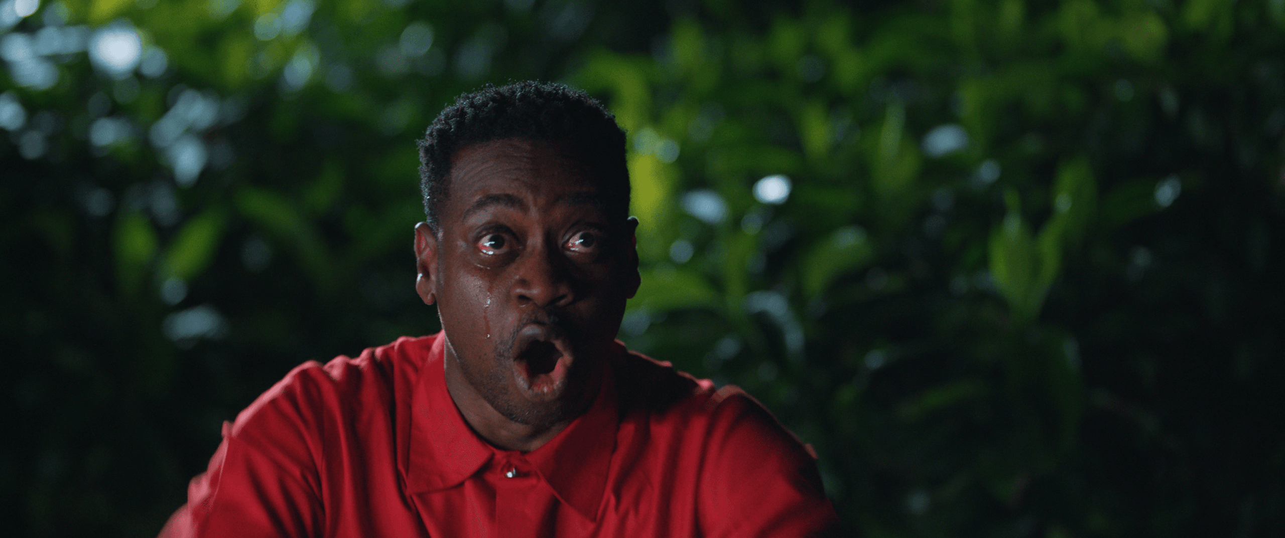 A man in red overcome with emotion